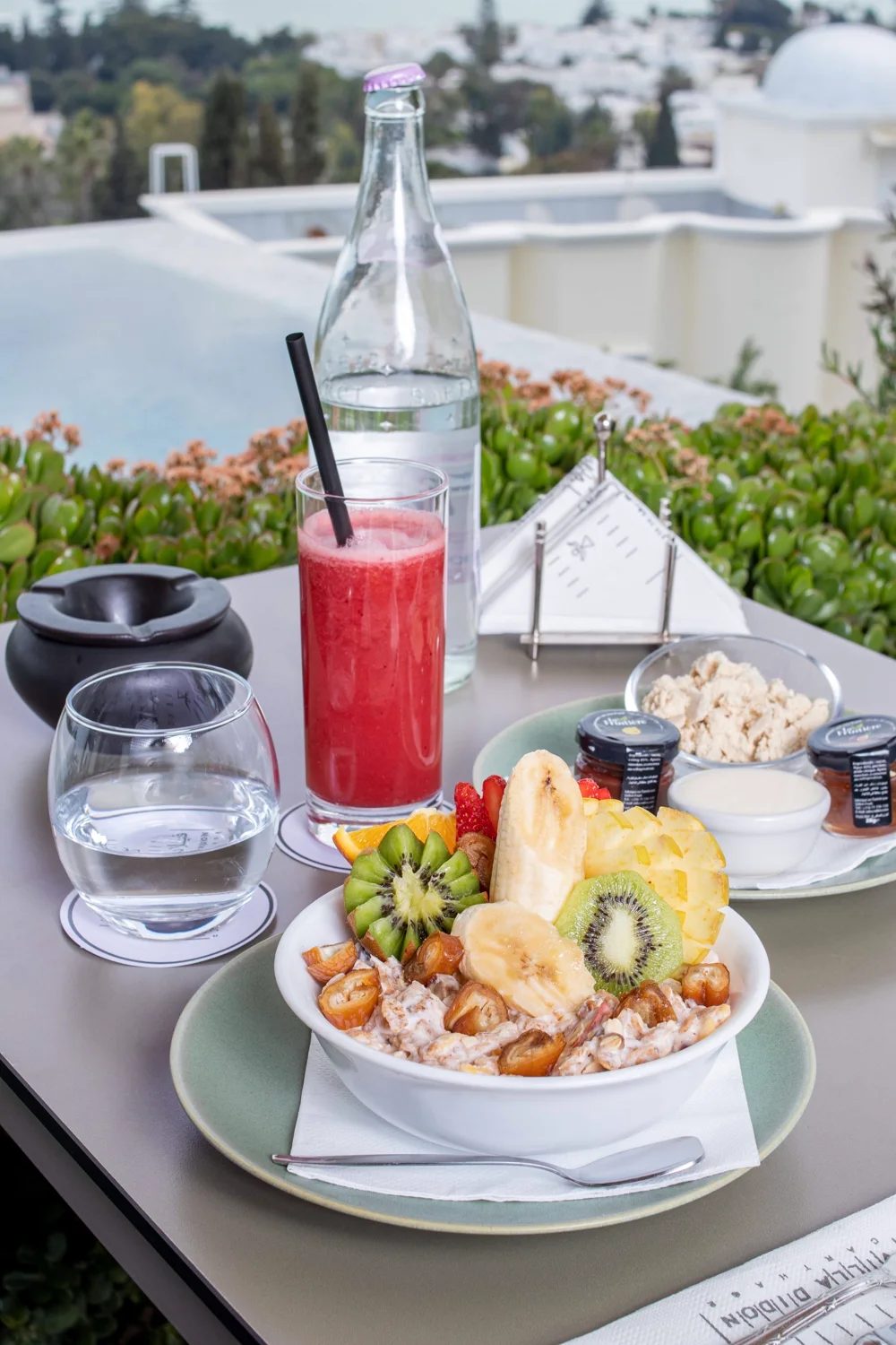 Muesli with fresh fruit and pressed juice at the pool's edge