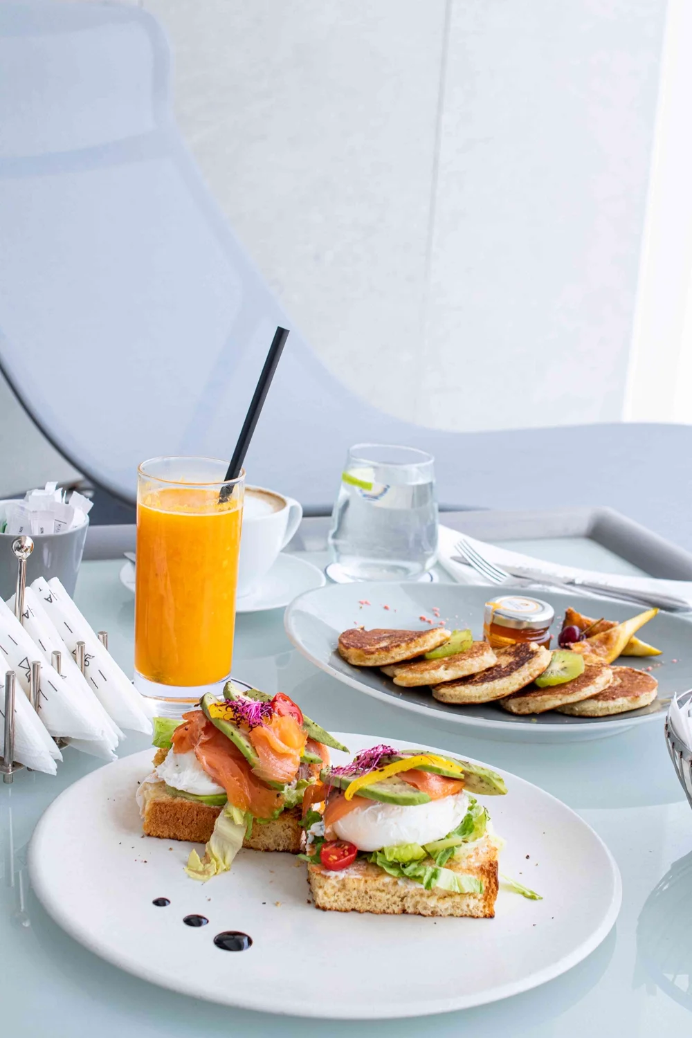 Avocado toast, pancakes and freshly pressed juices in the morning light