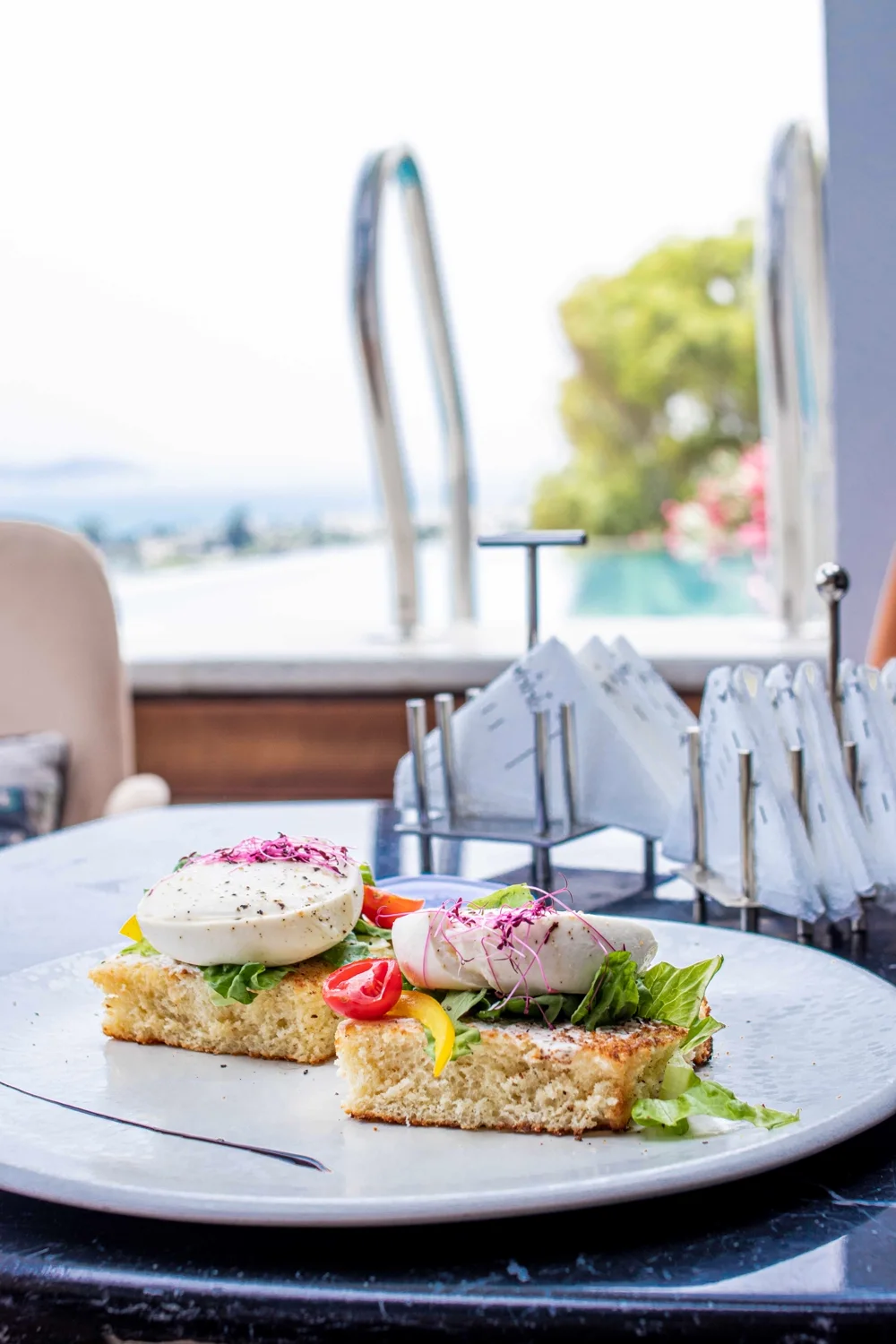 Poached eggs with salmon served at the pool's edge